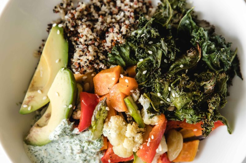 Quinoa, baked vegetables and healthy green goddess dressing buddha bowl