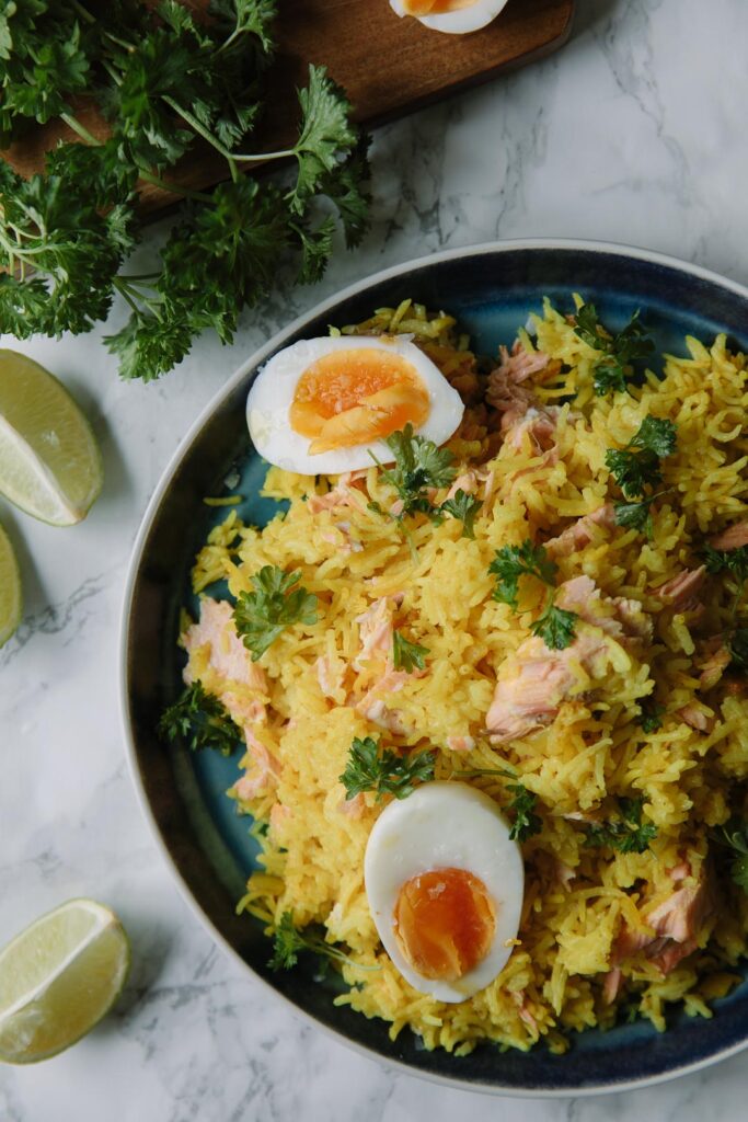 Yellow rice with poached salmon, boiled eggs and parsley